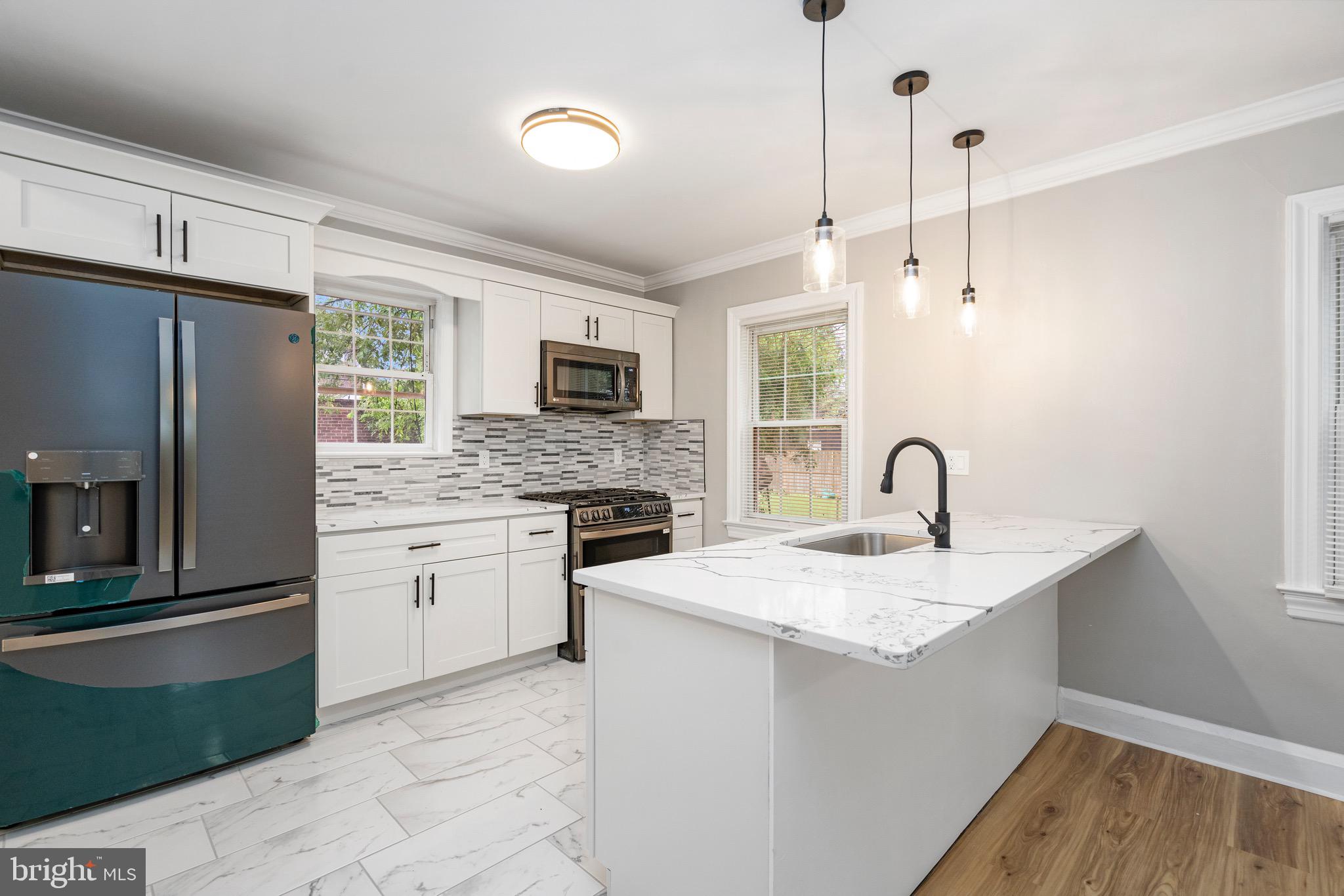 5311 Herring Run Drive Baltimore, MD 21214 - Photo 8 of 43 a kitchen with a sink stove and refrigerator