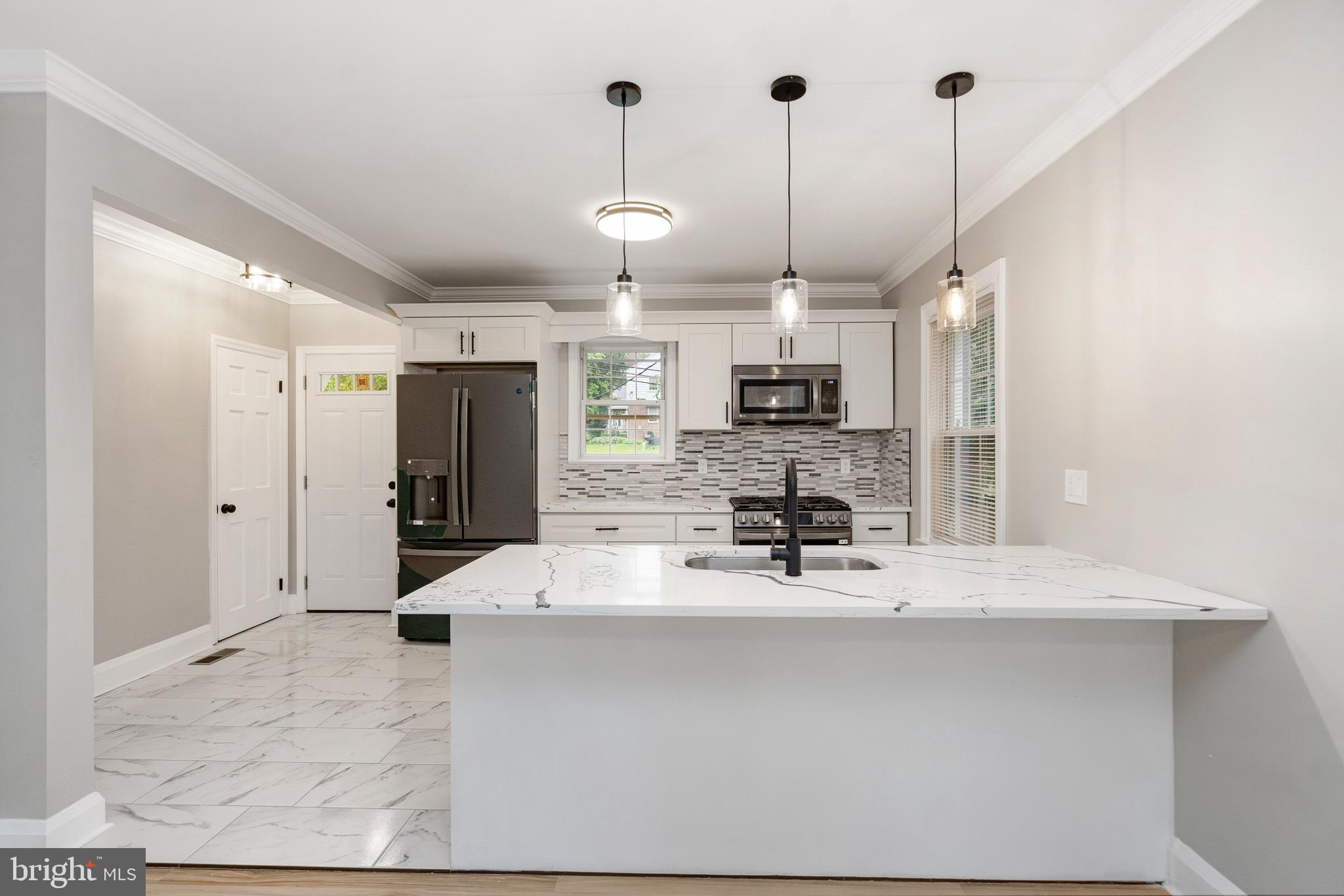 5311 Herring Run Drive Baltimore, MD 21214 - Photo 9 of 43 a large kitchen with a large counter top appliances and cabinets