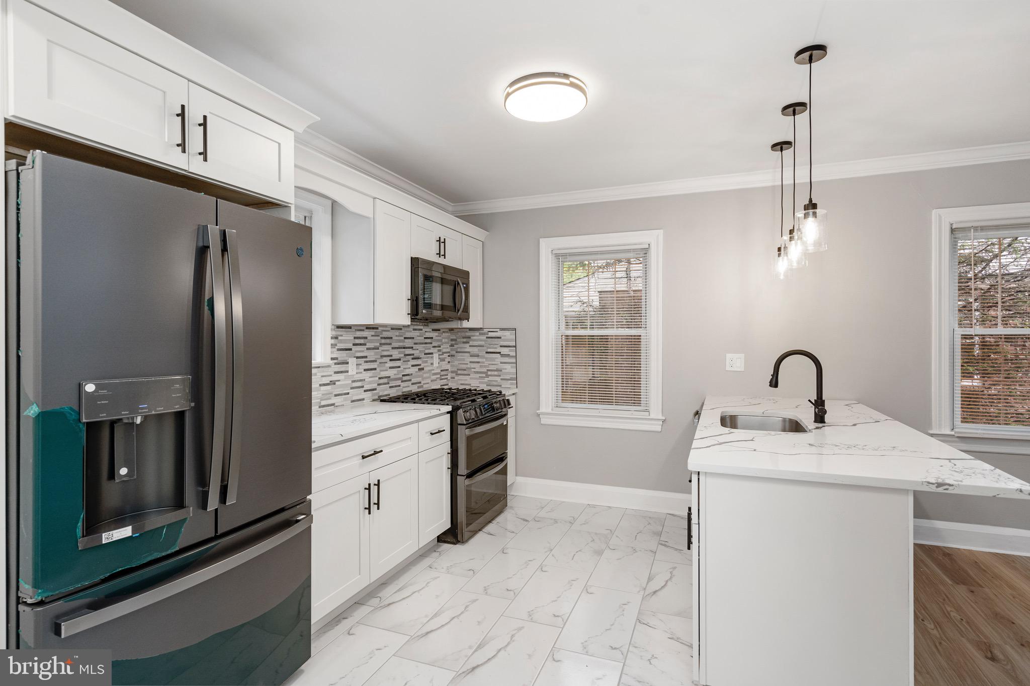 5311 Herring Run Drive Baltimore, MD 21214 - Photo 10 of 43 a kitchen with stainless steel appliances granite countertop a refrigerator sink stove and microwave