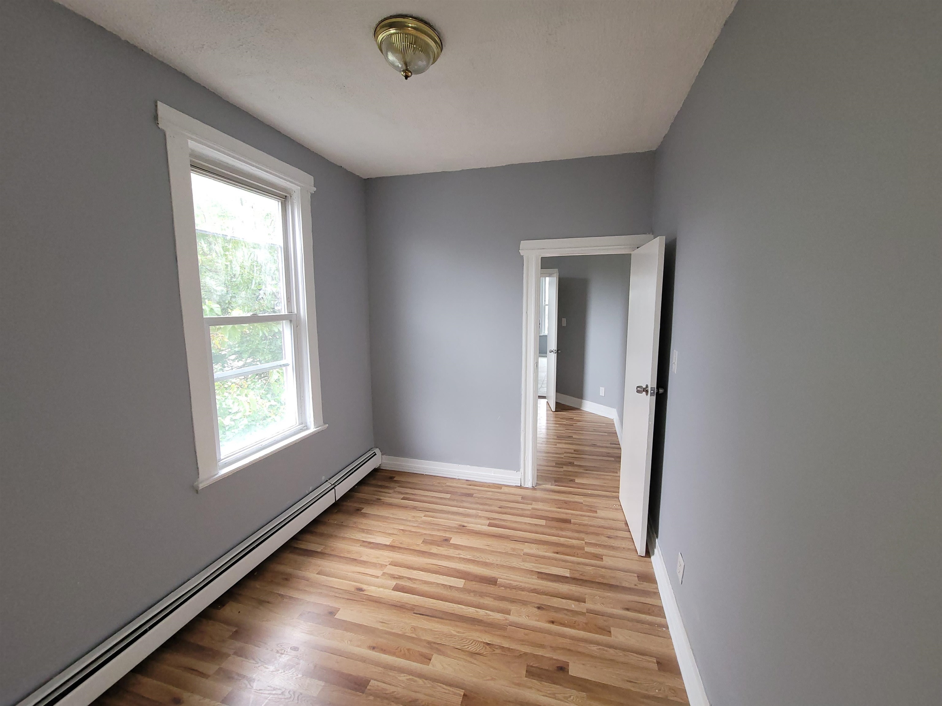 1700 John F. Kennedy Boulevard, Unit 3L Jersey City, NJ 07305 - Photo 12 of 13 a view of hallway with window and wooden floor