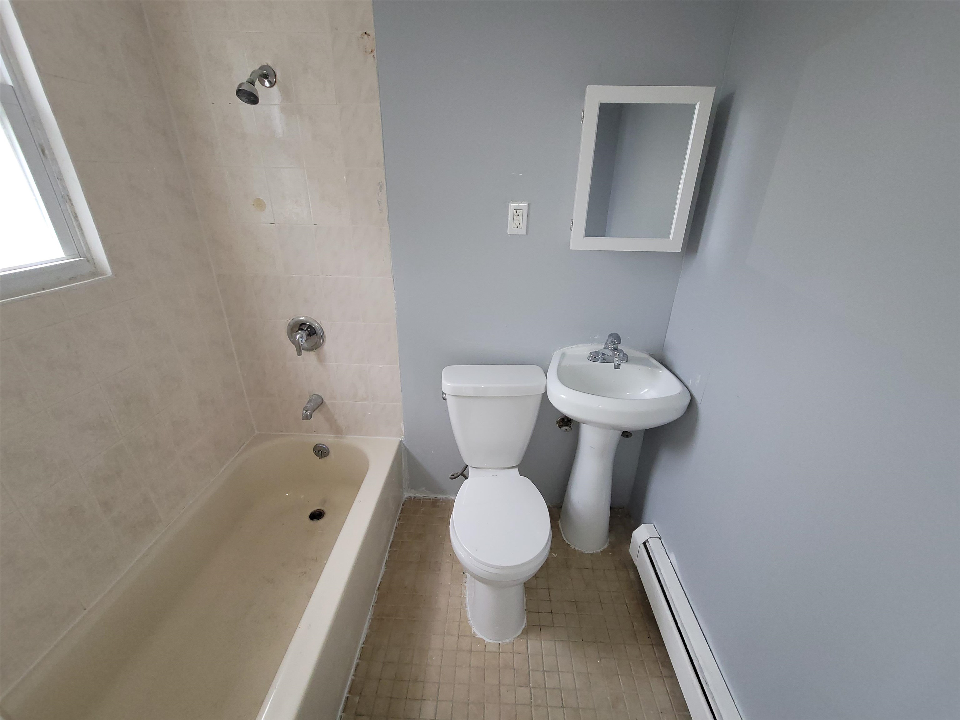 1700 John F. Kennedy Boulevard, Unit 3L Jersey City, NJ 07305 - Photo 13 of 13 a white toilet sitting next to a bathroom sink