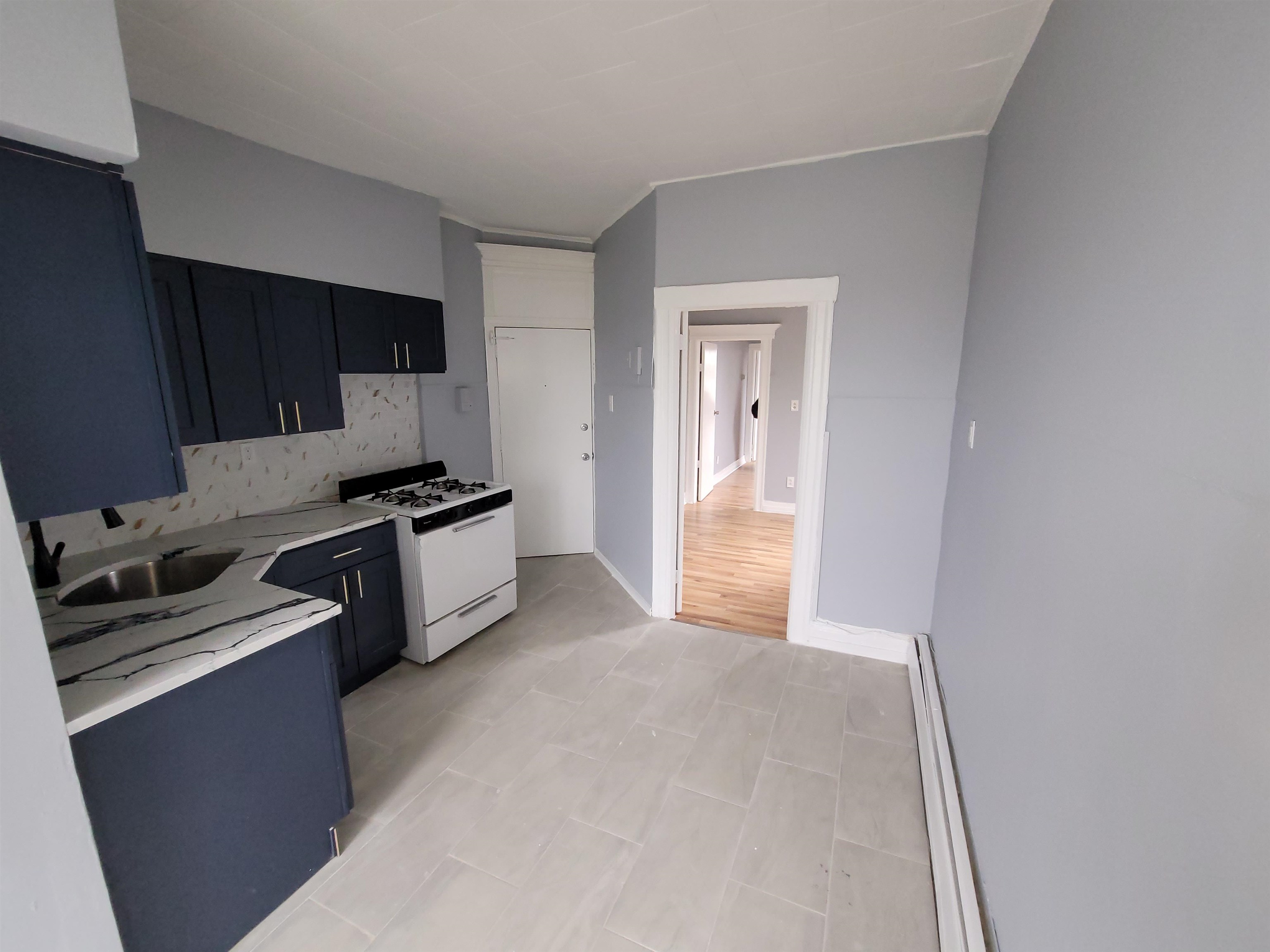 1700 John F. Kennedy Boulevard, Unit 3L Jersey City, NJ 07305 - Photo 3 of 13 a kitchen with a refrigerator and a stove top oven