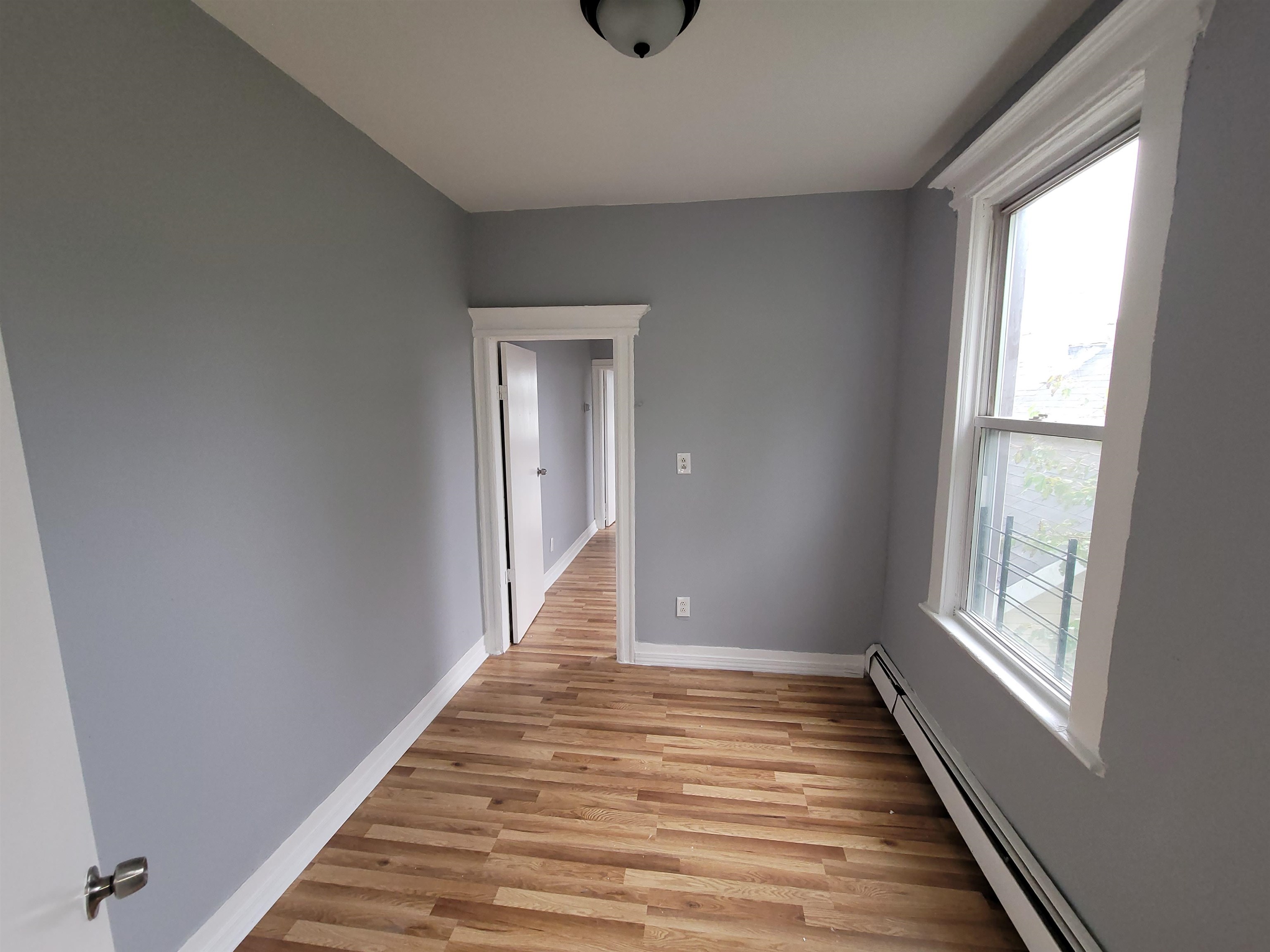 1700 John F. Kennedy Boulevard, Unit 3L Jersey City, NJ 07305 - Photo 10 of 13 a view of a hallway with wooden floor and windows