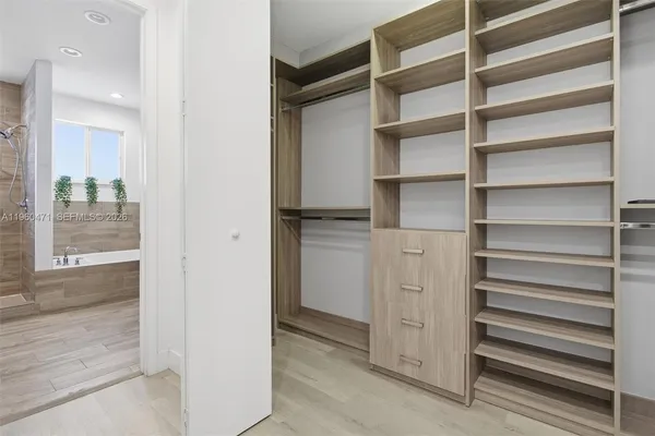 a view of walk in closet with empty racks