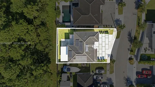 an aerial view of a house with table and chairs