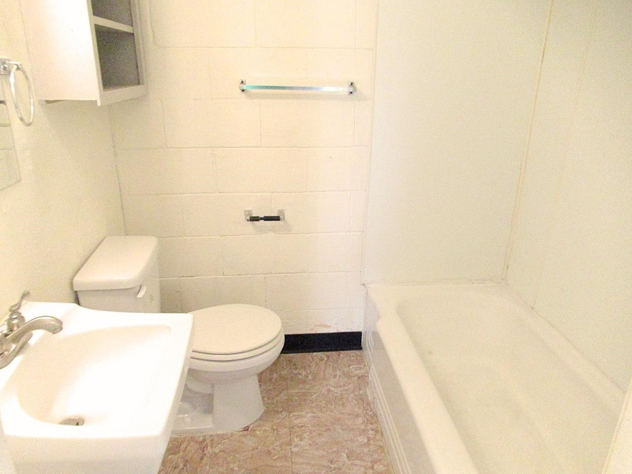 2220 29th Street, Unit R Lubbock, TX 79411 - Photo 3 of 4 a white toilet sitting next to a white tub