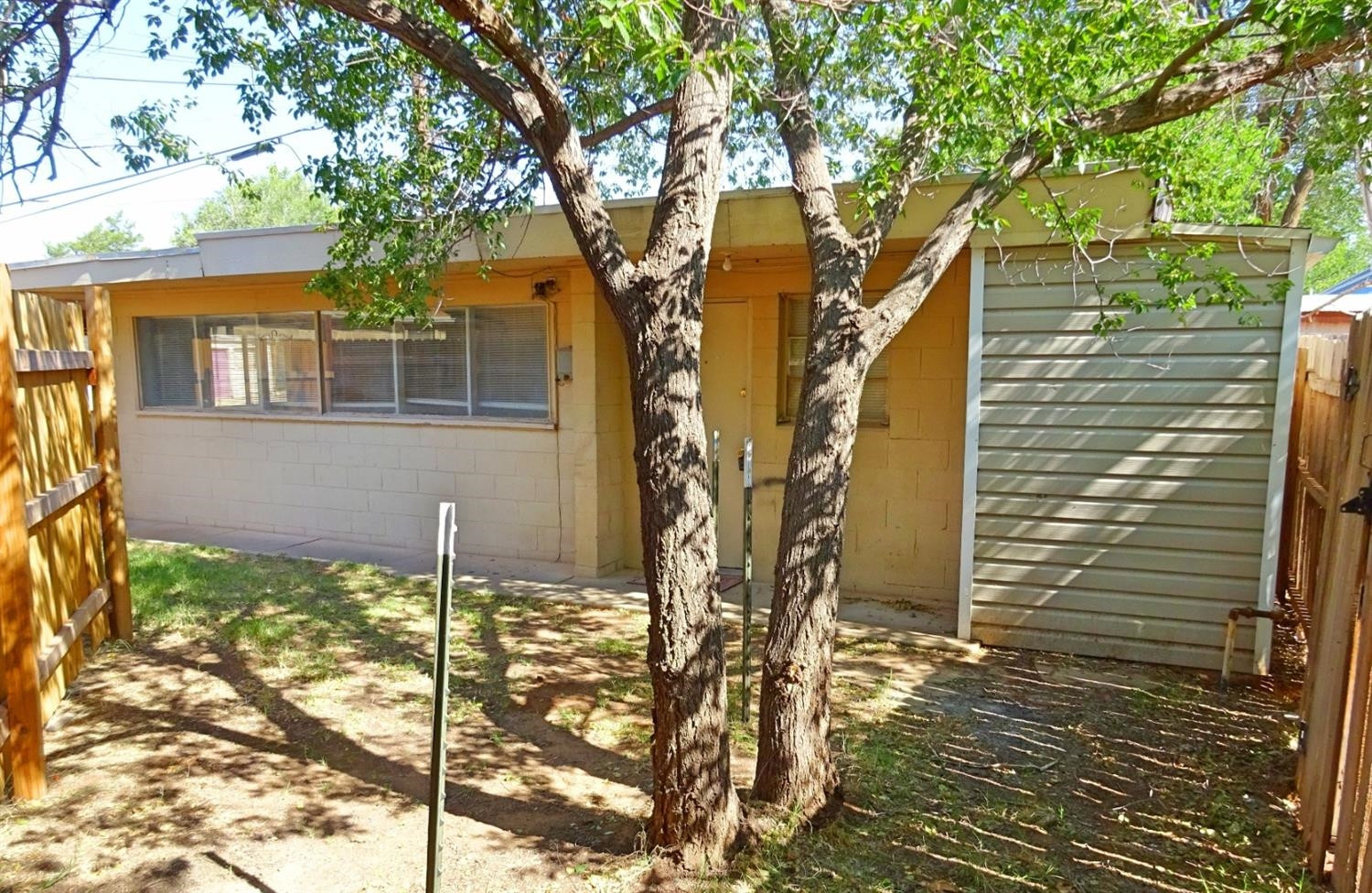 2220 29th Street, Unit R Lubbock, TX 79411 - Photo 4 of 4 a front view of a house with a yard