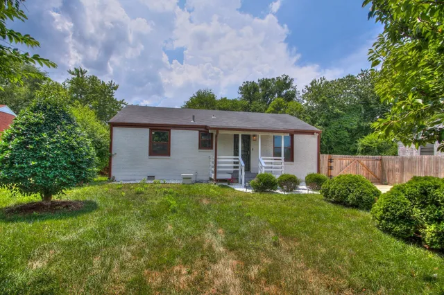 a view of a house with a yard and plants