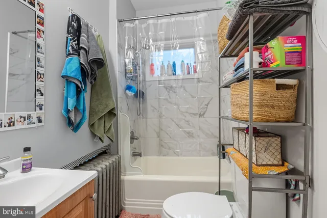 a bathroom with a sink a bath tub and a toilet