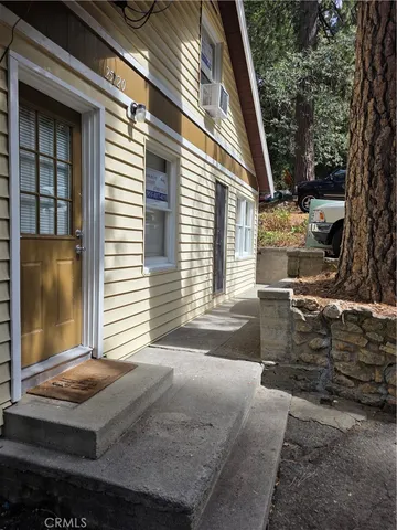 a front view of a house with trees