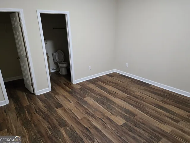 a view of a room with wooden floor and sink