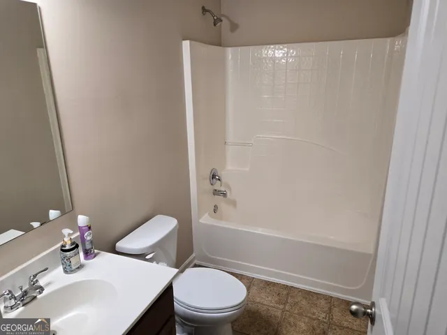 a view of a room that has wooden floor and a window