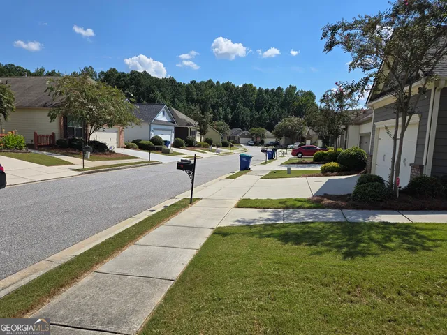 a view of a swimming pool with a patio and a garden