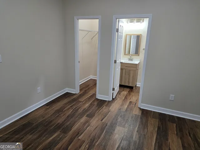 a view of a room with wooden floor and a sink
