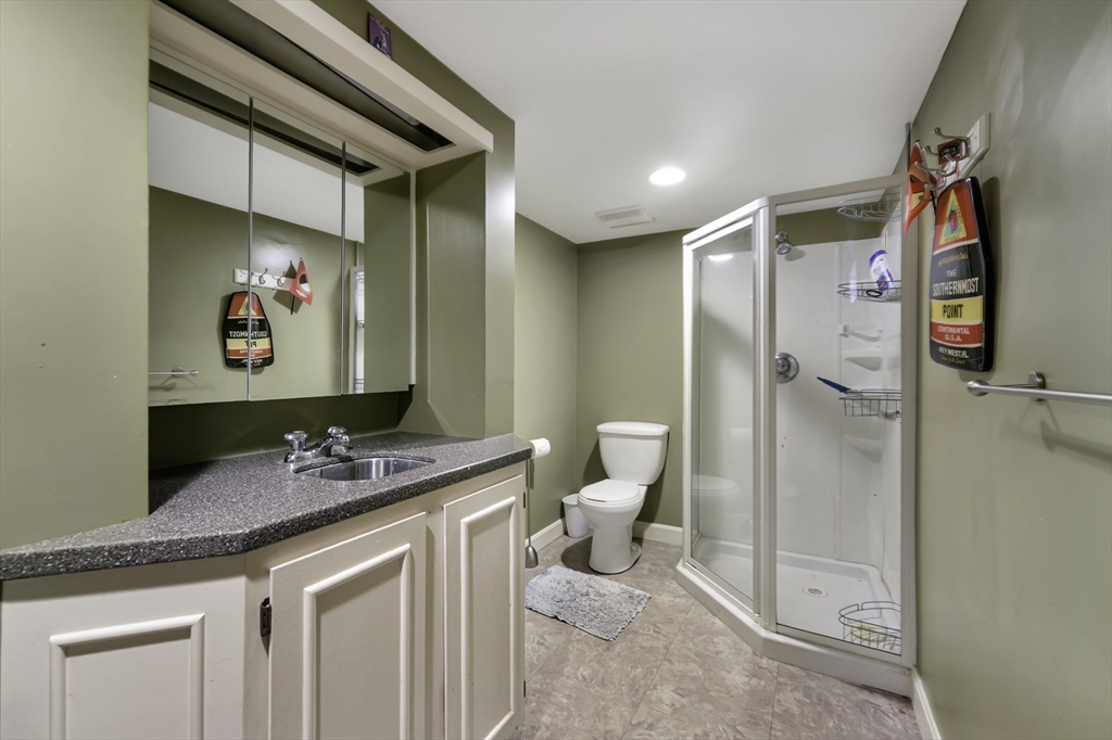 1350 Phillips Road New Bedford, MA 02745 - Photo 14 of 17 a bathroom with a granite countertop sink a toilet and a shower