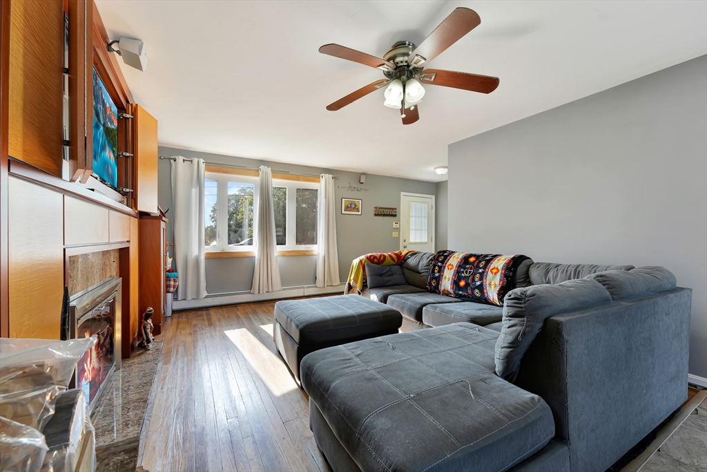 1350 Phillips Road New Bedford, MA 02745 - Photo 4 of 17 a living room with furniture fireplace and a flat screen tv