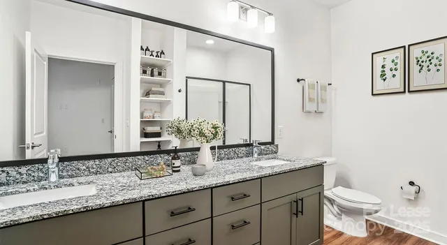 a bathroom with a granite countertop sink and a mirror