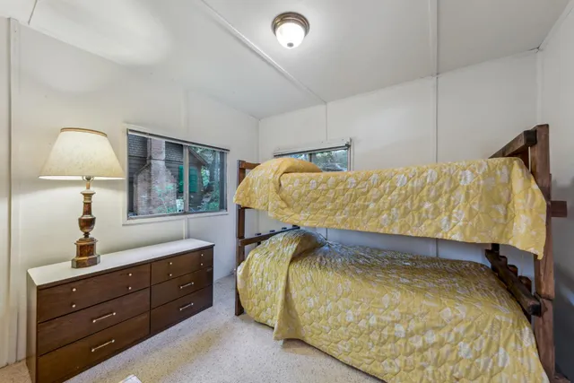 a bed room with a bed and a mirror