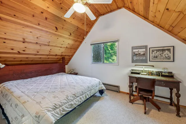 a bedroom with a bed a desk and chair