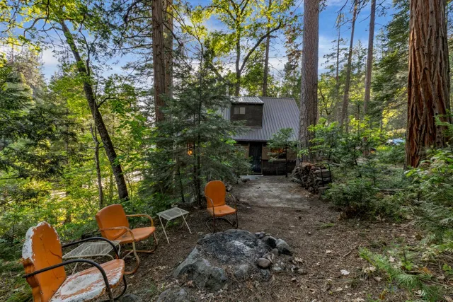 a backyard of a house with table and chairs