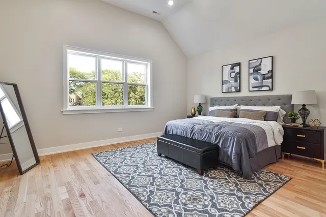 a bedroom with a large bed and a window