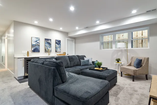 a living room with furniture and a potted plant