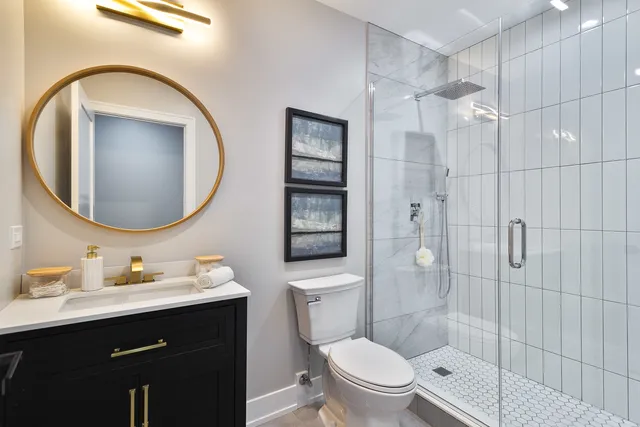 a bathroom with a toilet a sink and mirror