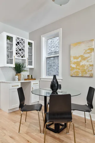 a work room with furniture a rug and a window