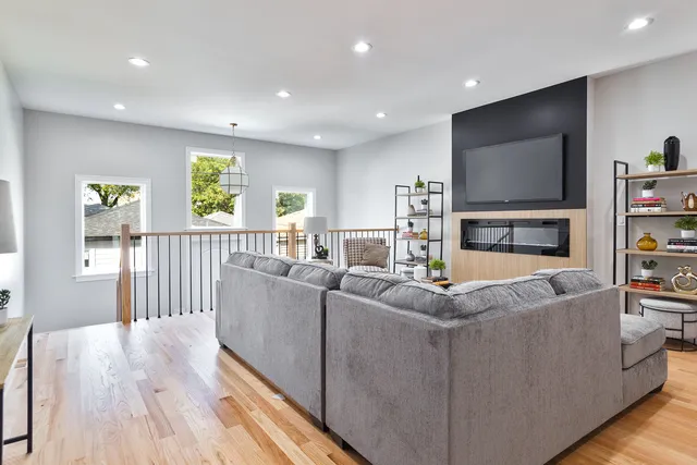 a living room with fireplace furniture and a flat screen tv