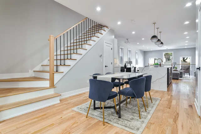 a dining room with furniture wooden floor and a rug