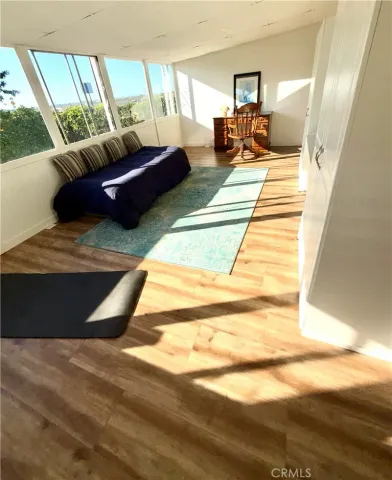 a living room with a couch and floor to ceiling windows