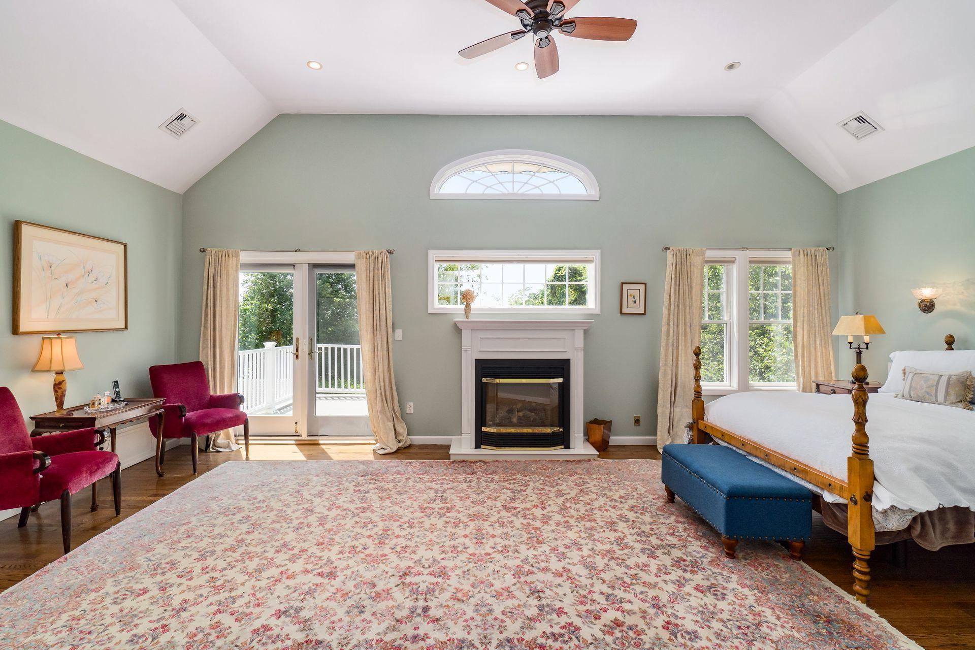 33 Pine Point Road Rowayton, CT 06853 - Photo 14 of 28 a spacious bedroom with a bed and a chandelier