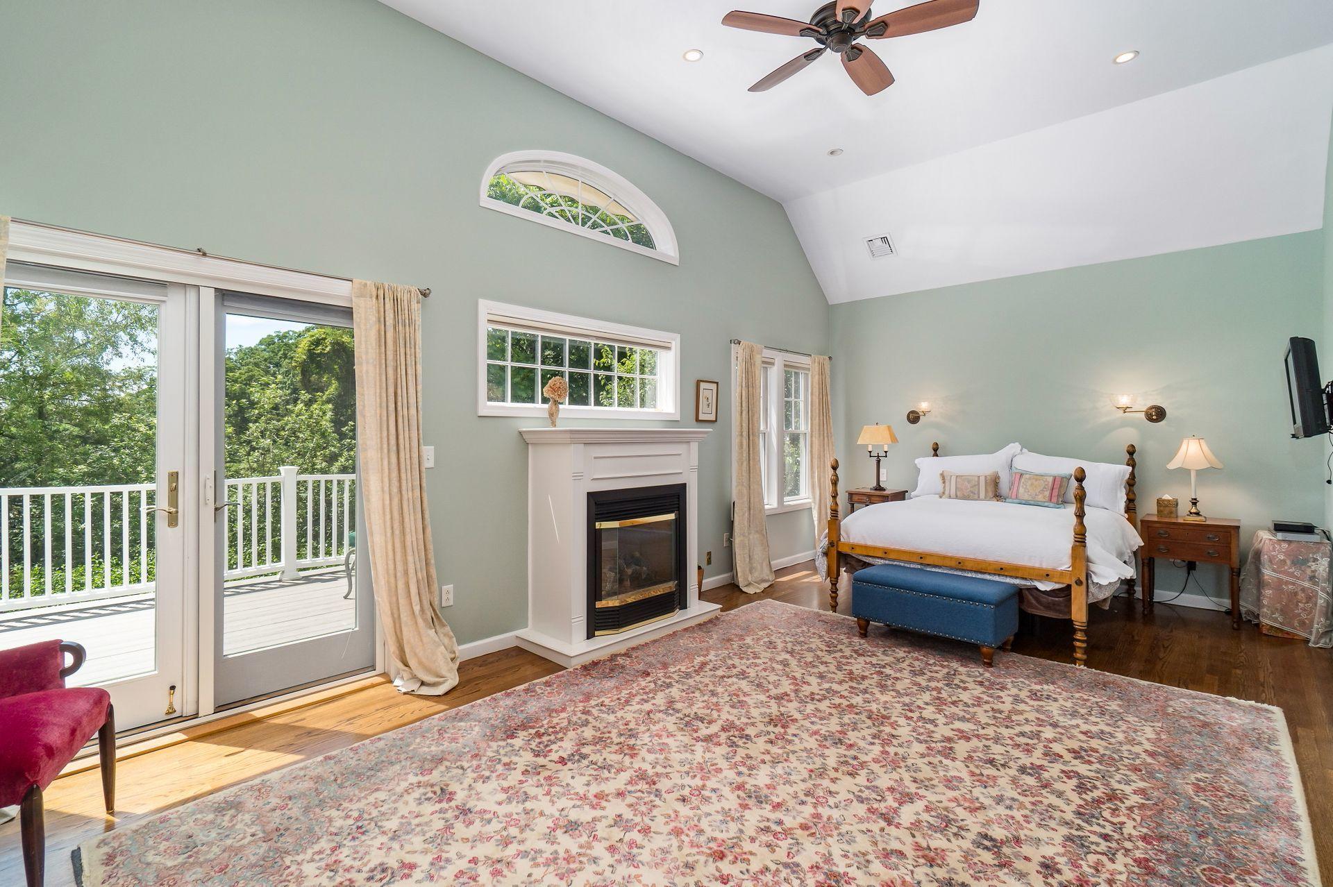 33 Pine Point Road Rowayton, CT 06853 - Photo 15 of 28 a bedroom with a bed and a fireplace