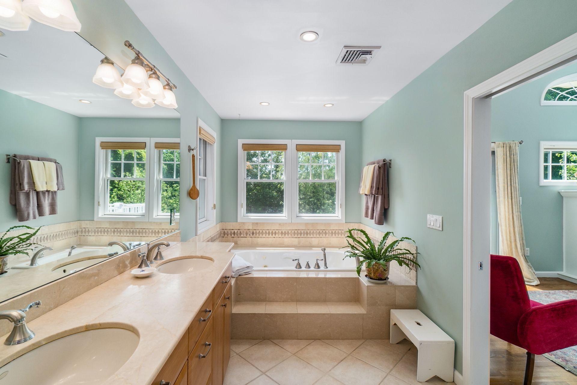 33 Pine Point Road Rowayton, CT 06853 - Photo 17 of 28 a bathroom with a granite countertop tub a sink and a large mirror