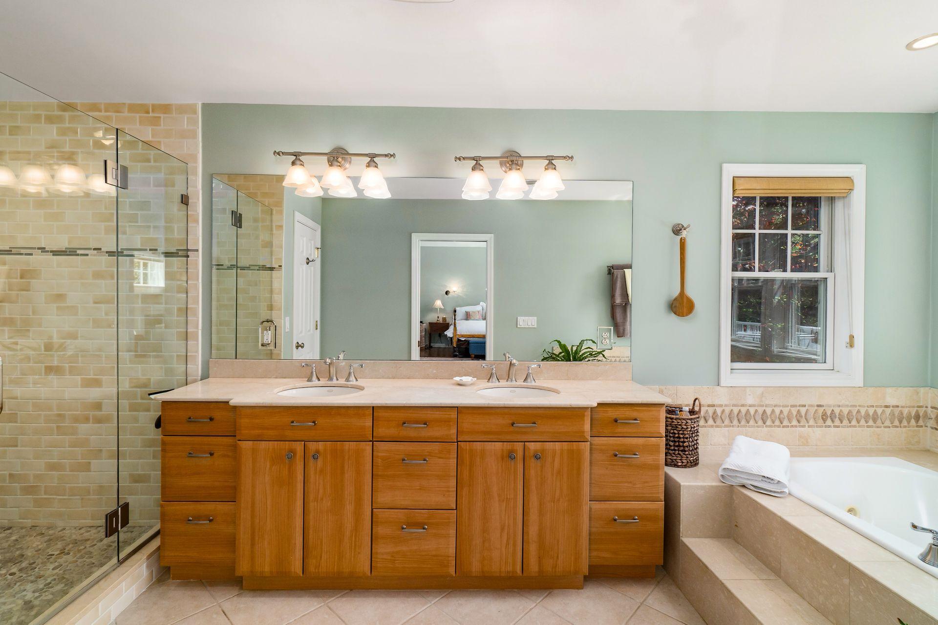 33 Pine Point Road Rowayton, CT 06853 - Photo 18 of 28 a spacious bathroom with a tub sink and mirror