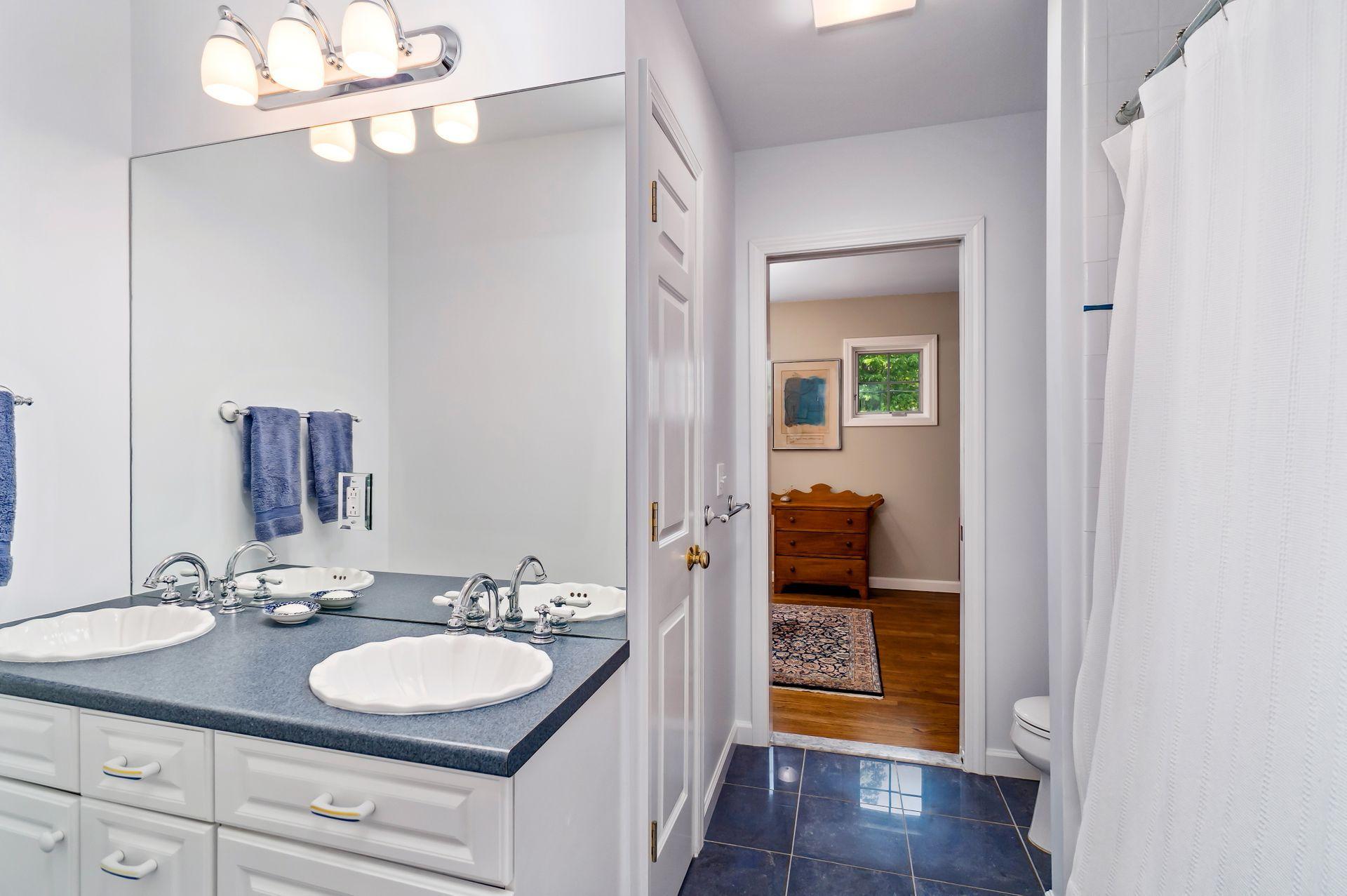 33 Pine Point Road Rowayton, CT 06853 - Photo 22 of 28 a en suite bathroom with a sink and a mirror