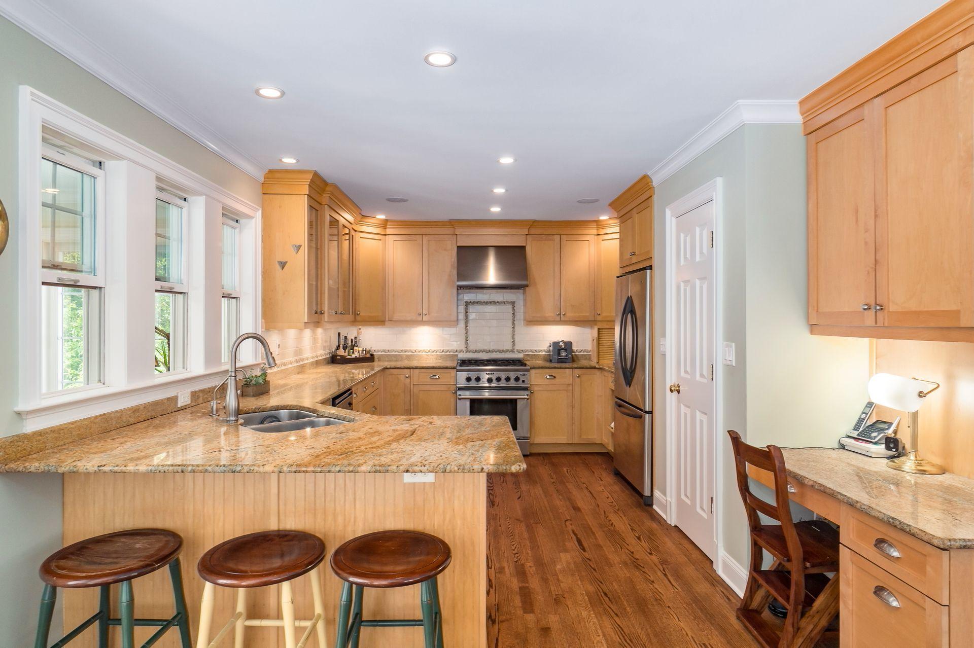33 Pine Point Road Rowayton, CT 06853 - Photo 7 of 28 a kitchen with a table chairs refrigerator and cabinets