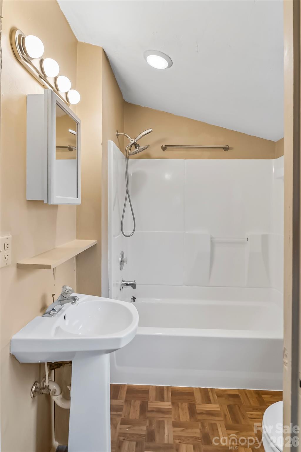 102 Rhododendron Drive Brevard, NC 28712 - Photo 12 of 17 a bathroom with a sink a mirror and a bathtub