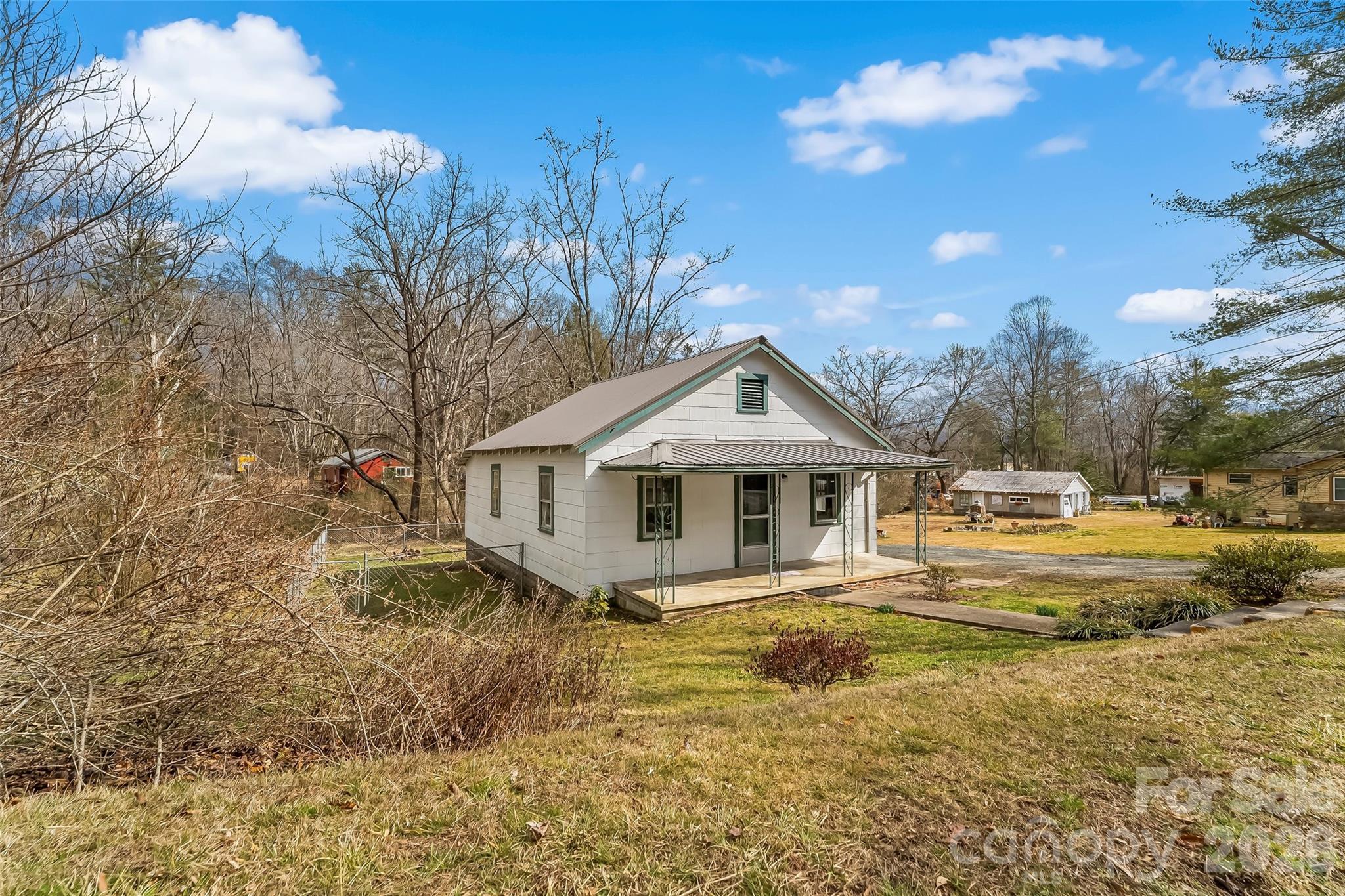 102 Rhododendron Drive Brevard, NC 28712 - Photo 2 of 17 a view of a house with a yard and large tree