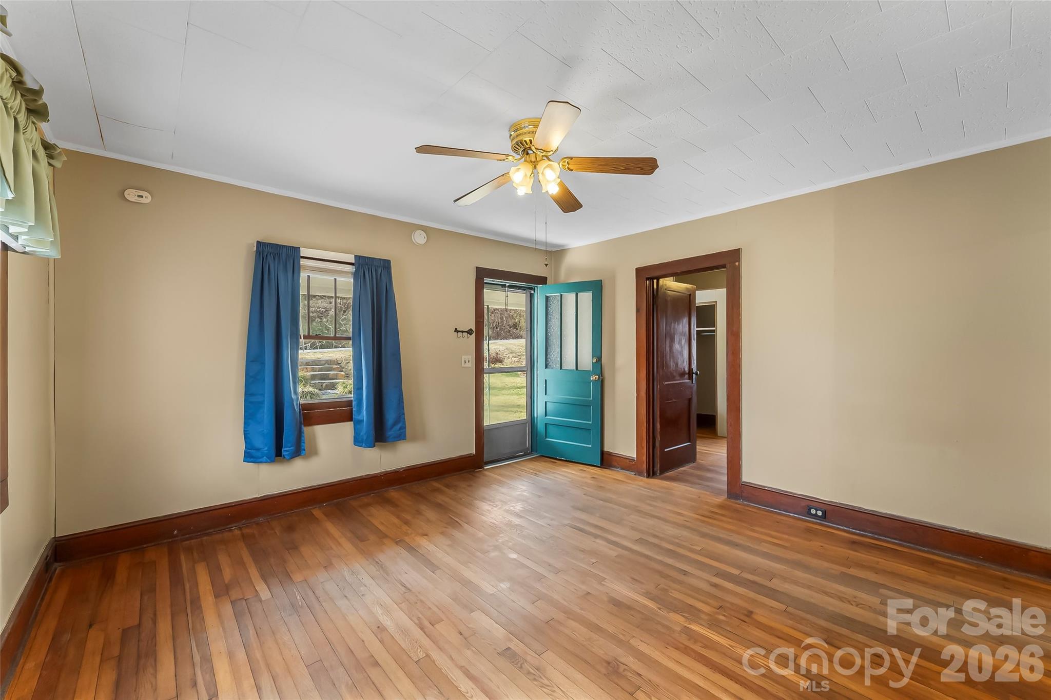 102 Rhododendron Drive Brevard, NC 28712 - Photo 4 of 17 a view of an empty room with window and wooden floor