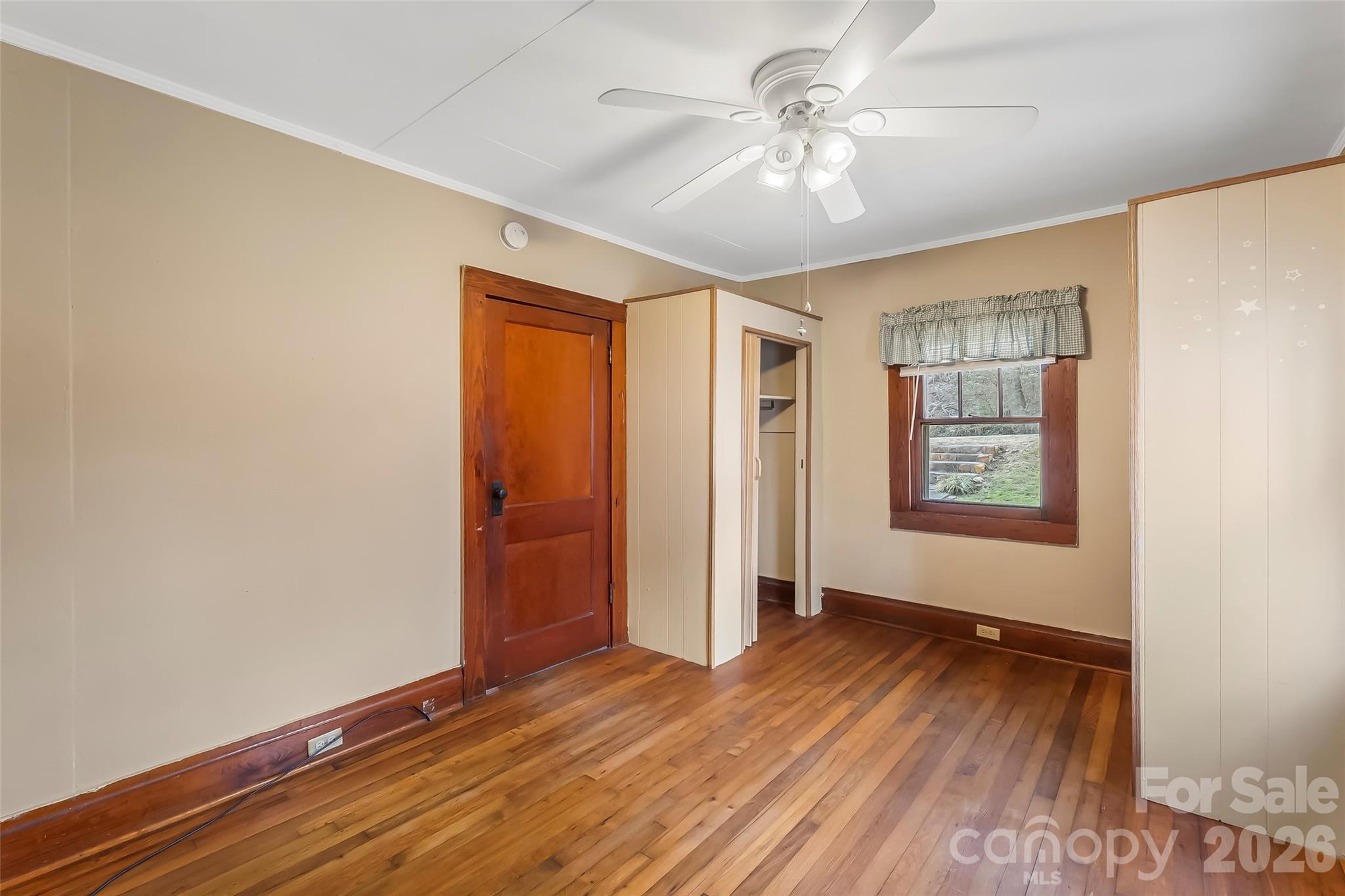 102 Rhododendron Drive Brevard, NC 28712 - Photo 6 of 17 wooden floor in an empty room with a window