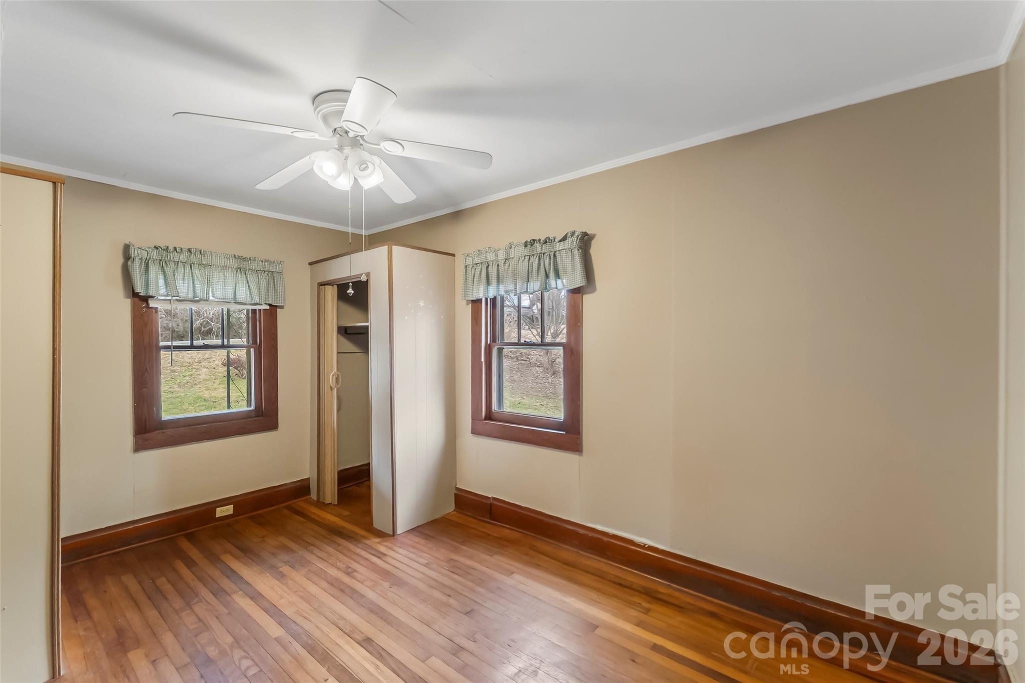 102 Rhododendron Drive Brevard, NC 28712 - Photo 7 of 17 a view of an empty room with window and wooden floor