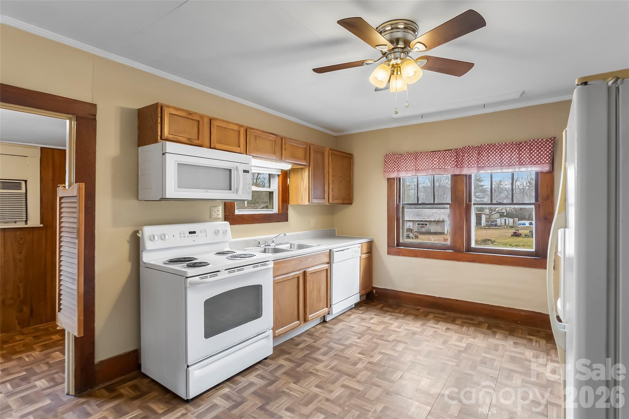 102 Rhododendron Drive Brevard, NC 28712 - Photo 9 of 17 a kitchen with a stove a sink and a refrigerator