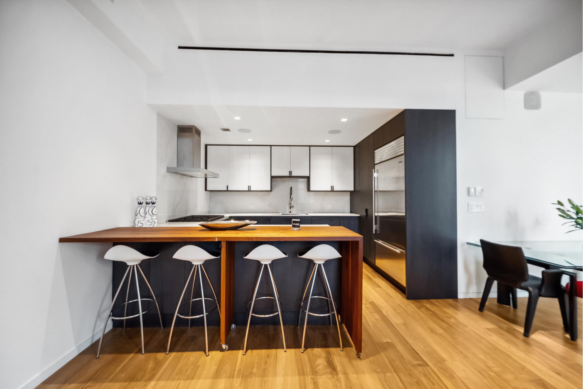 240 Centre Street, Unit 5B Manhattan, NY 10013 - Photo 9 of 37 a kitchen view with a table and chairs in it