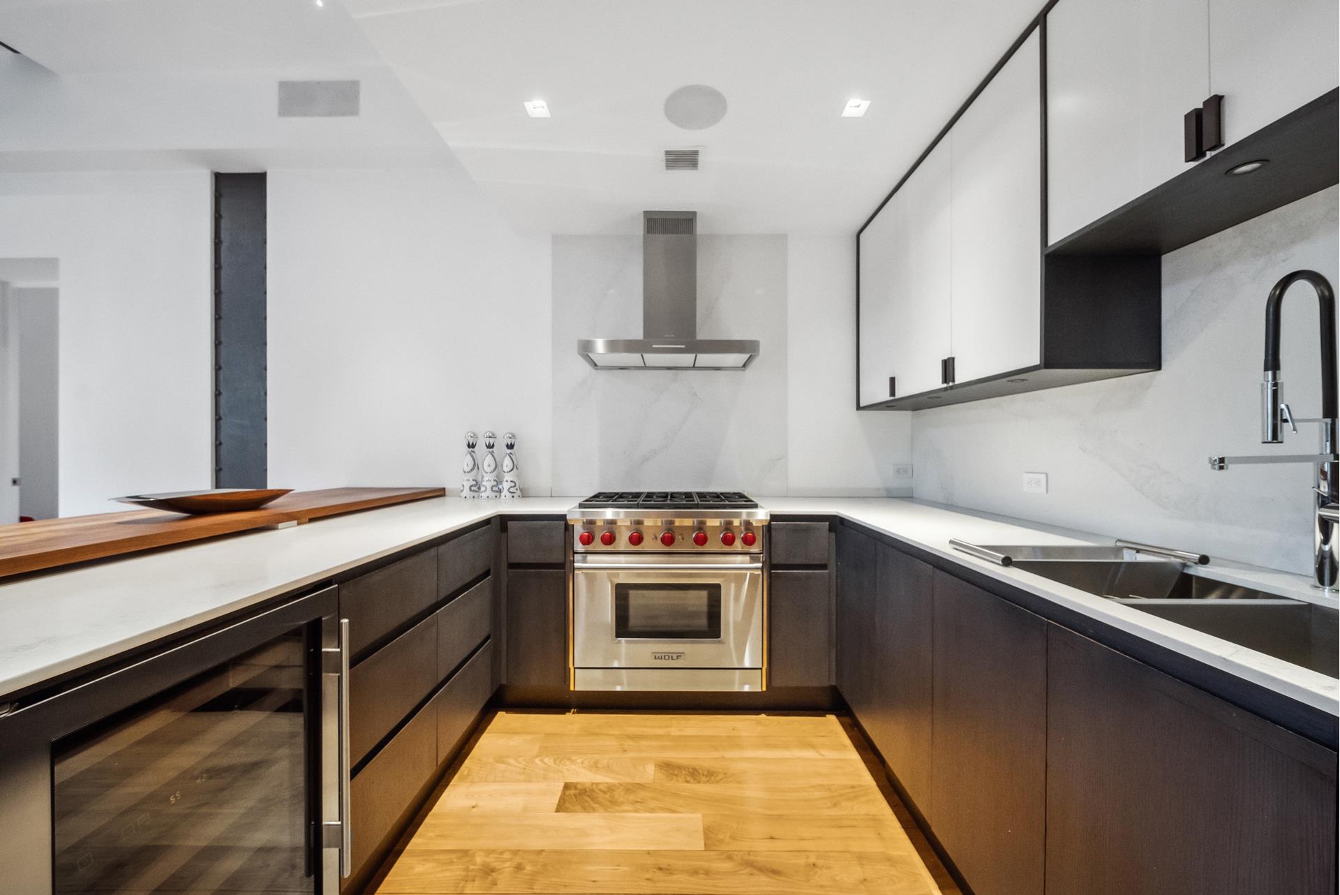 240 Centre Street, Unit 5B Manhattan, NY 10013 - Photo 10 of 37 a kitchen with stainless steel appliances granite countertop a sink a stove and a refrigerator