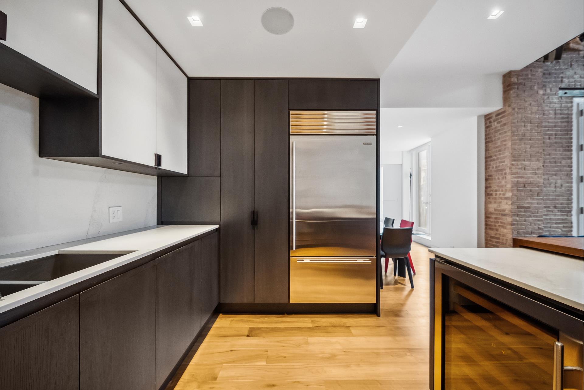 240 Centre Street, Unit 5B Manhattan, NY 10013 - Photo 11 of 37 a view of kitchen with a sink and a refrigerator