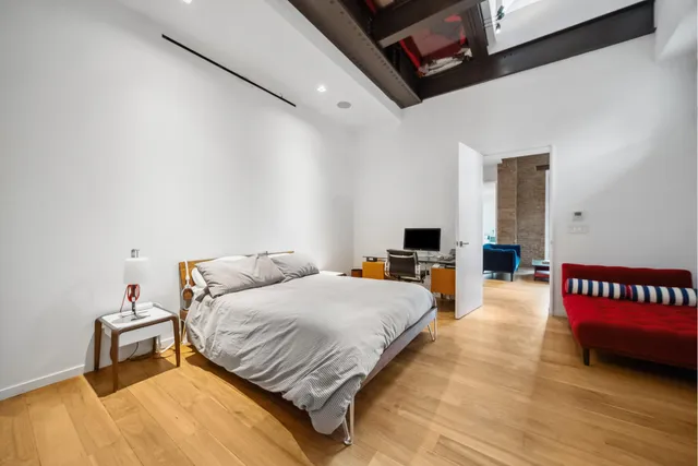 a bedroom with a bed and white walls