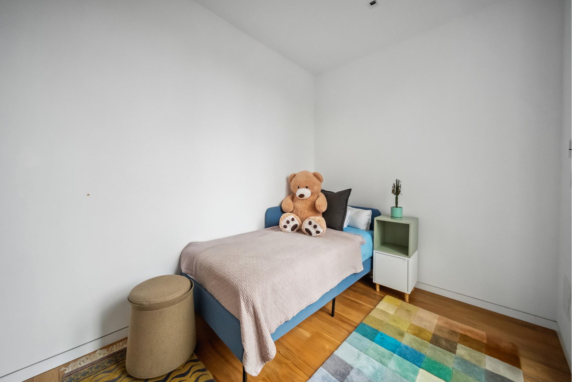 240 Centre Street, Unit 5B Manhattan, NY 10013 - Photo 22 of 37 a bedroom with a bed and a lamp on the dresser
