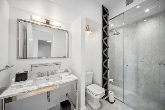 a bathroom with a tub a sink and mirrors