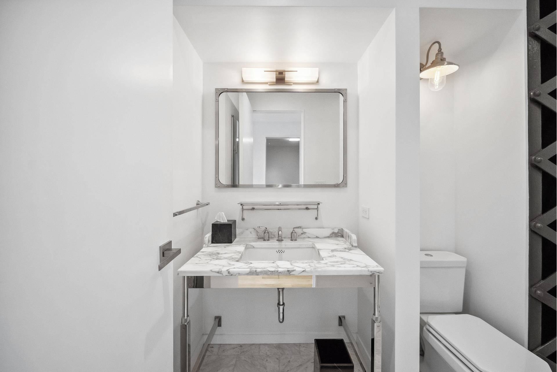 240 Centre Street, Unit 5B Manhattan, NY 10013 - Photo 24 of 37 a bathroom with a sink and a mirror